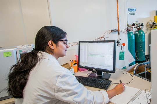 Researcher analyzing data on a computer.