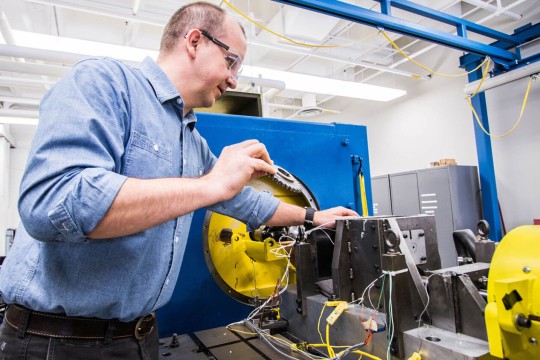 A man in goggles testing transmission dynamometer.