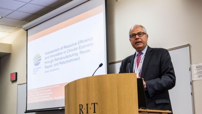 CIMS conference speaker at podium.