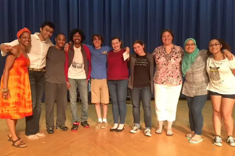 Ten members of the cast and crew of 'One Class, Many Stories', posing for a photo.