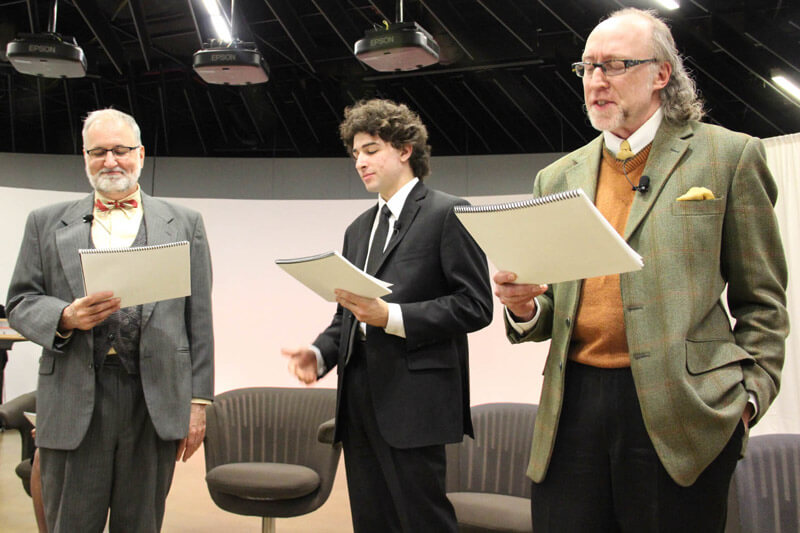 Three people doing a play reading of Photograph 51.