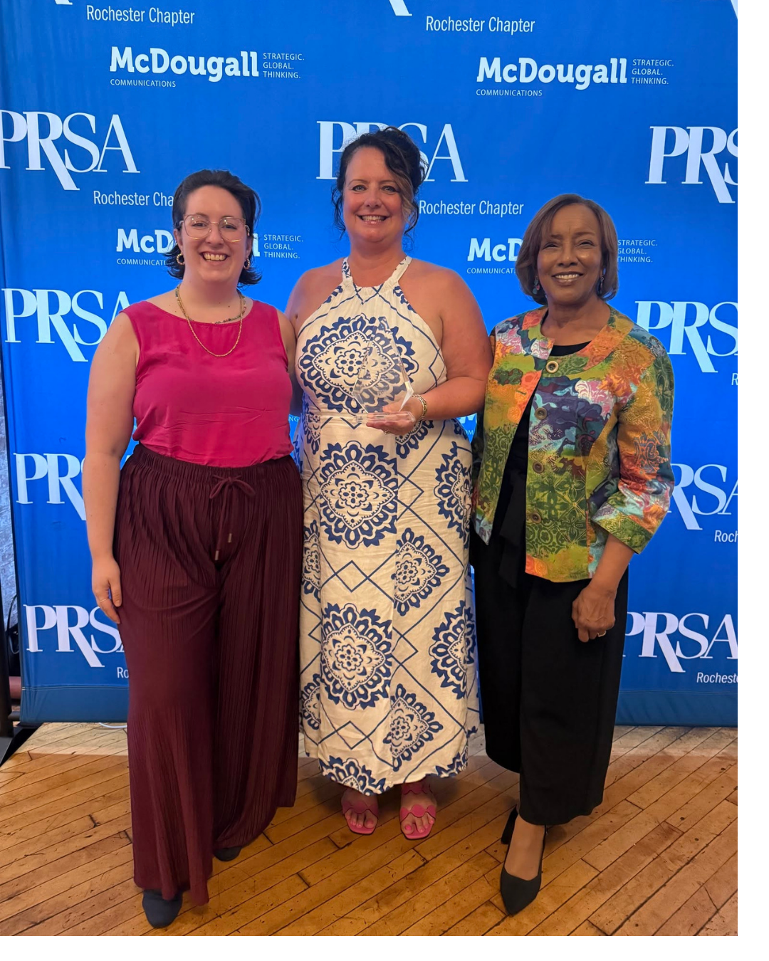 Photo of three women with an award