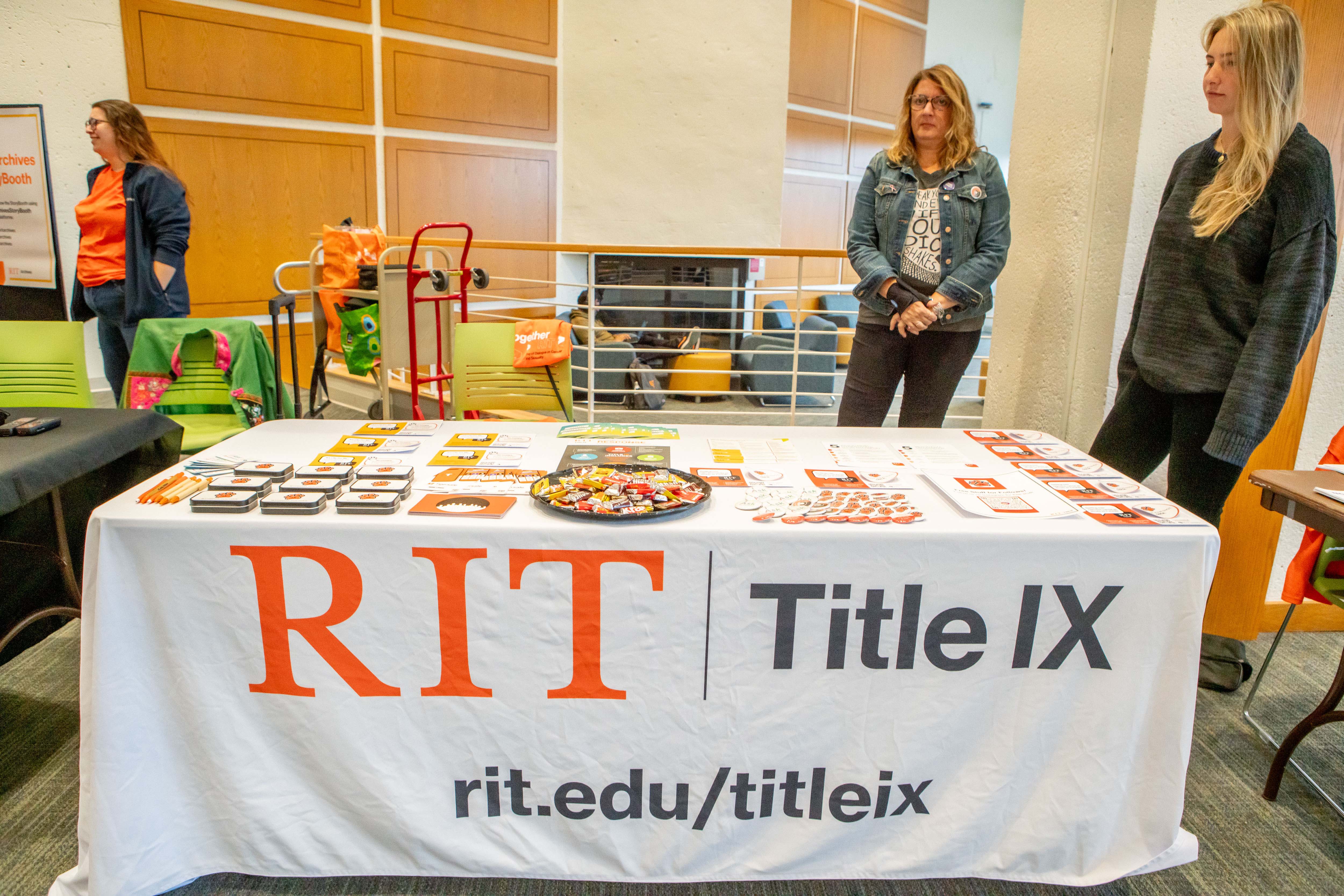 two women standing behind table display 