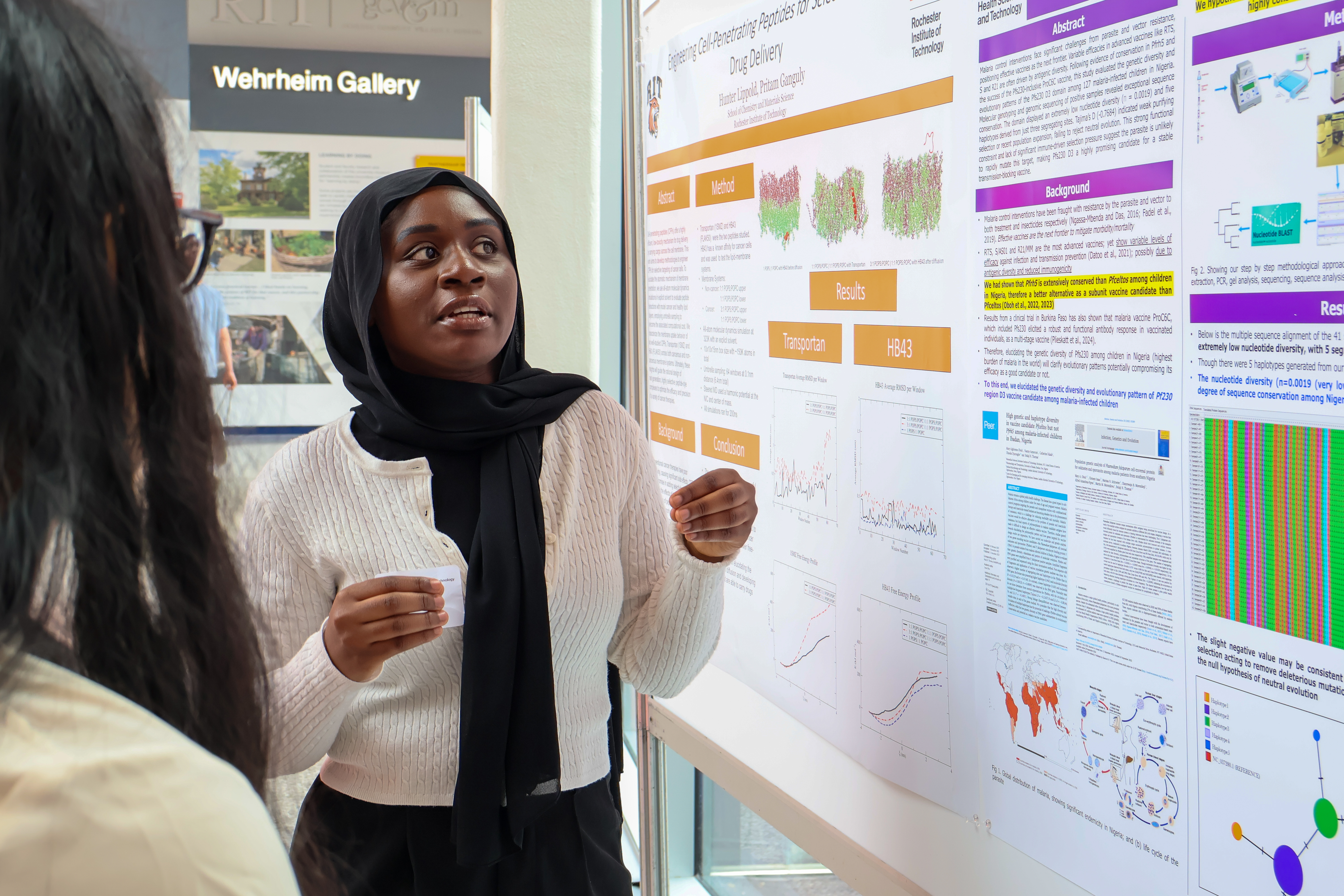 Photo of a woman presenting infront of a poster