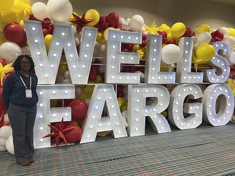 Student in front of Well Fargo Sign 