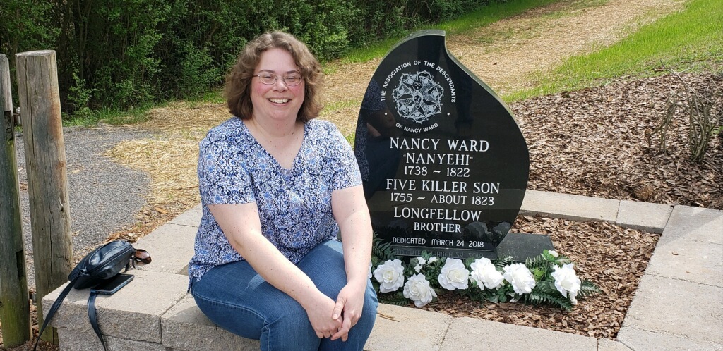 Woman sitting next to Nancy Ward memorial