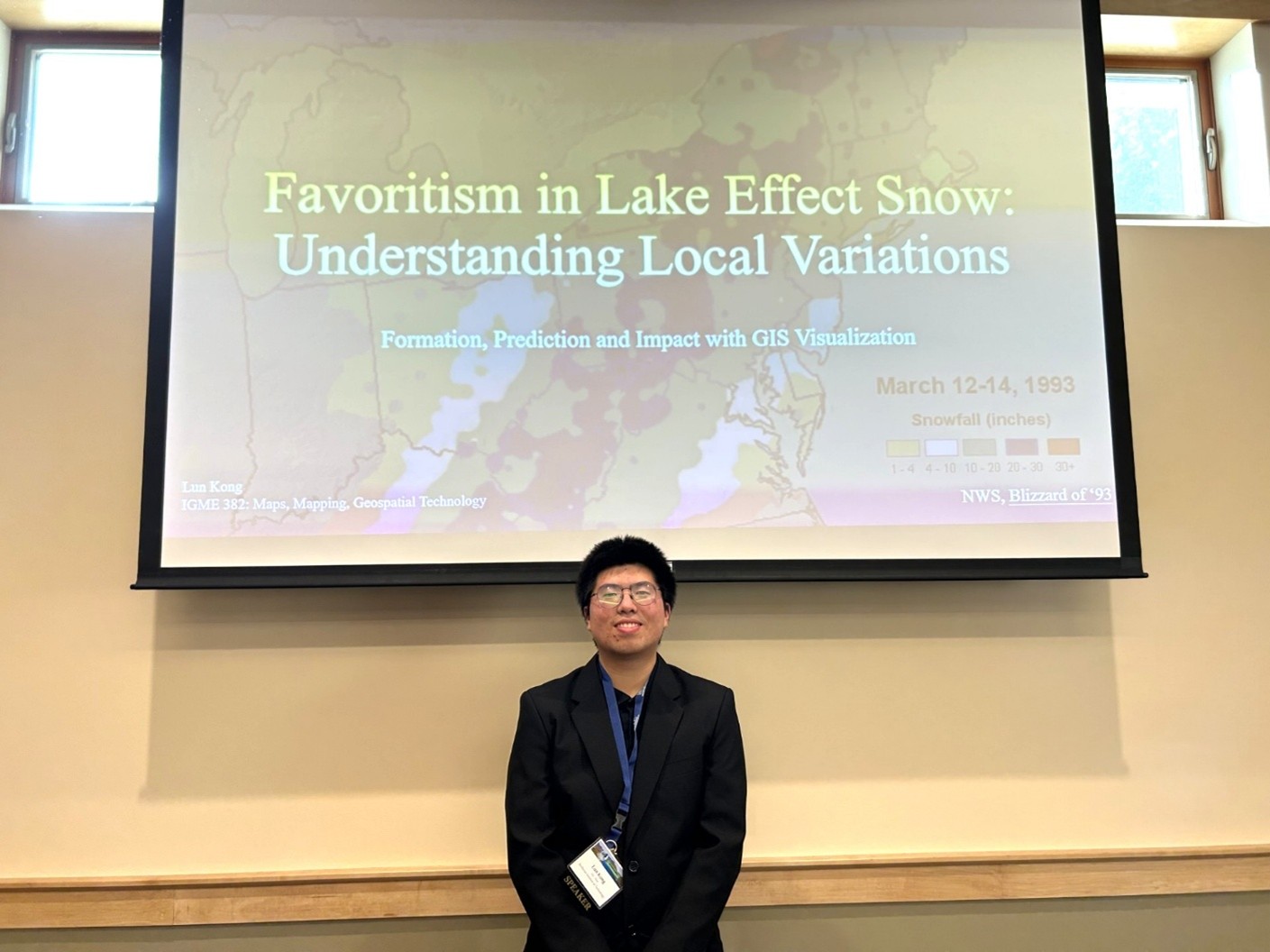 Male studnet standing in from on projection screen