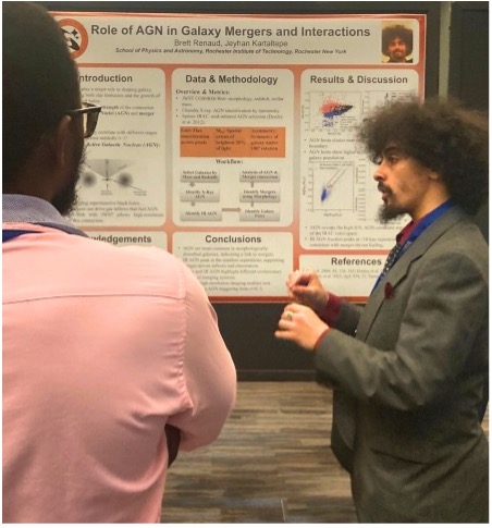 Man speaking in front of of a research board