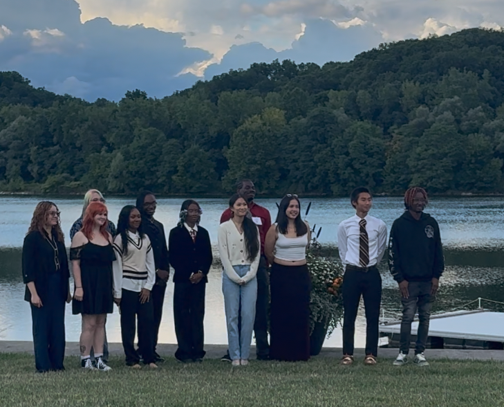 Studnets in front of a lake