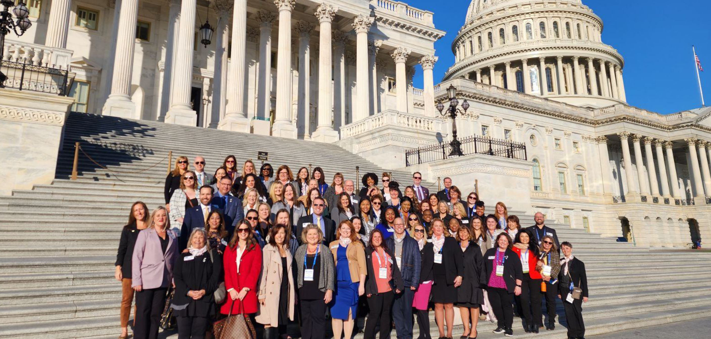 large group of people standing on stairs of US Capitol