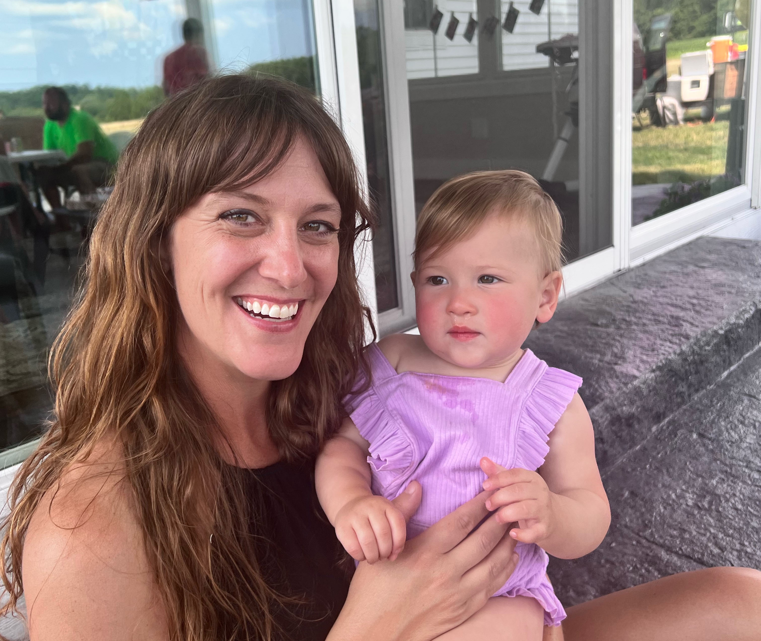 photo of woman holding baby