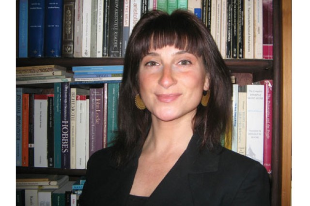 Professor posing in front of books