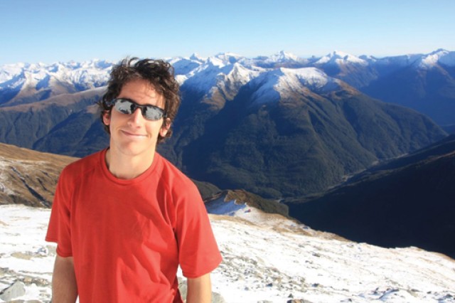 Person standing on top of a mountain