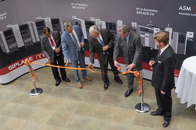 People cutting the ribbon at ceremony 
