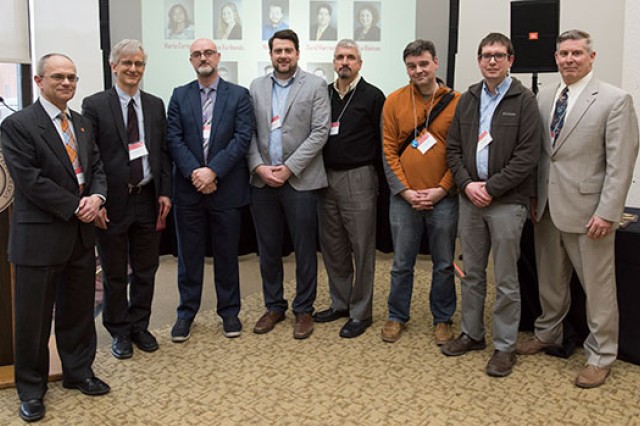 Researchers line up and pose for a photo.