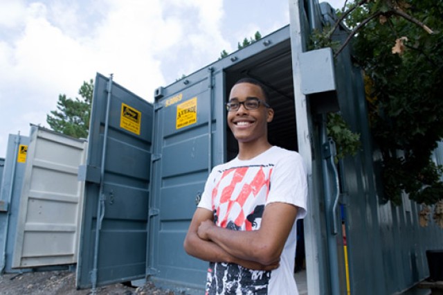 Student standing in front of shipping container