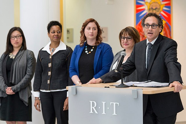 People accepting awards on stage in gallery