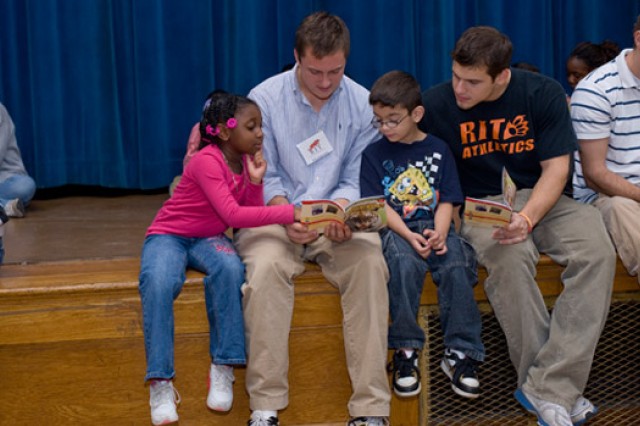 Student reading books to kids