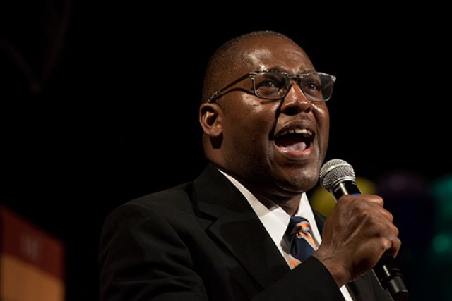 man singing into a microphone.