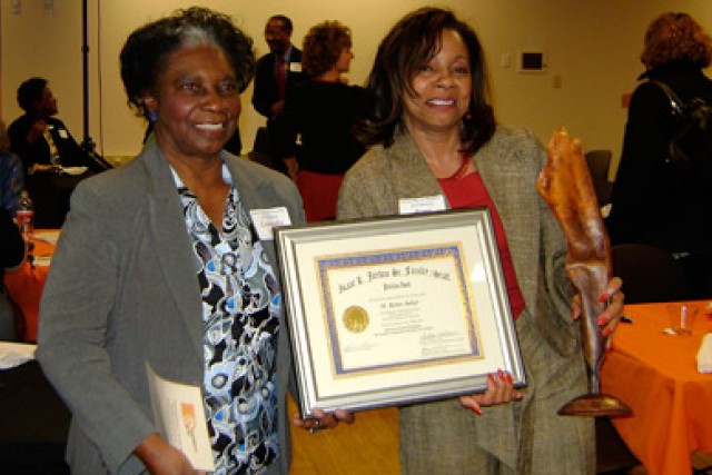 People posing with award