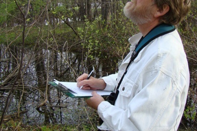 Professor with clipboard observing nature