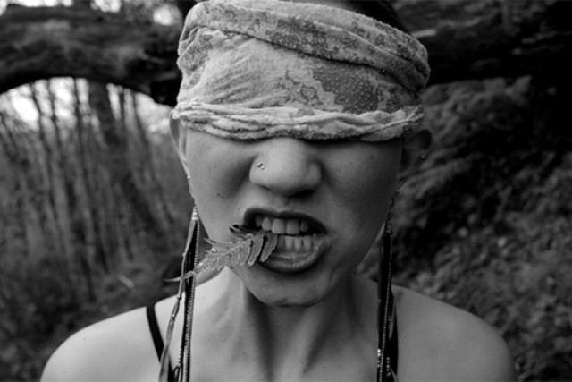 Picture of person eating leaf with blindfold on