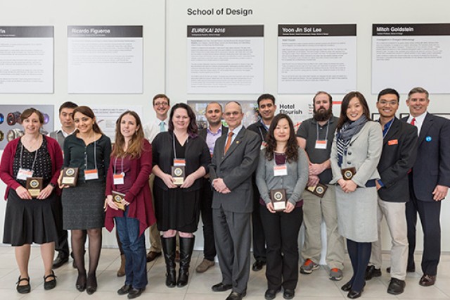Group of Researchers gathered in front of Research posters