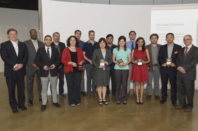 group of researchers holding awards and posing for a photo.
