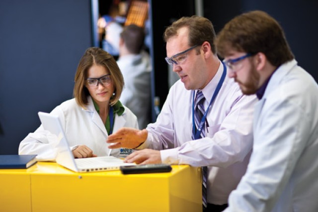 Three Researchers looking at computer