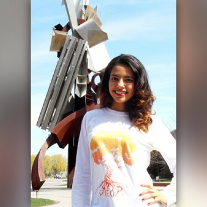 Person posing in front of statue