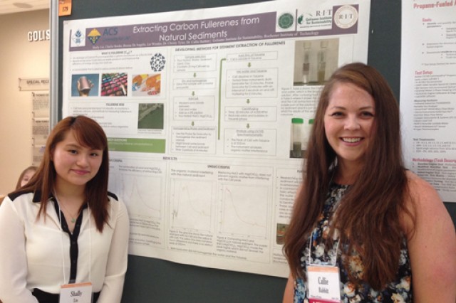 Two people standing near poster