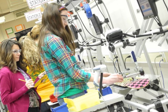 students making skateboards in an assembly line.
