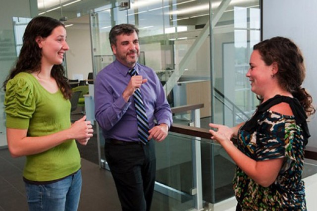 Three people talking inside