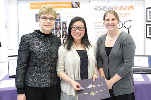 People posing infront of display 