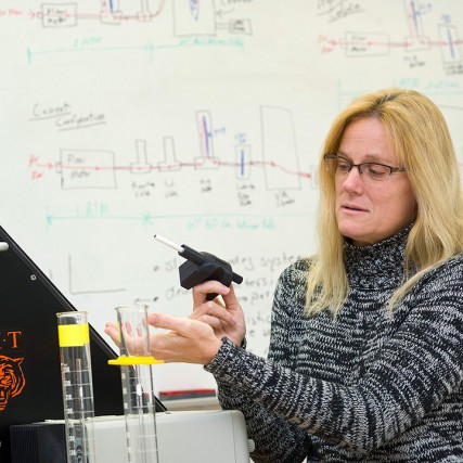 Researcher holds device that measure cigarette smoke