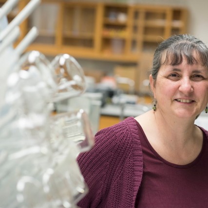 Head-and-shoulders view of researcher wearing maroon top and cardigan