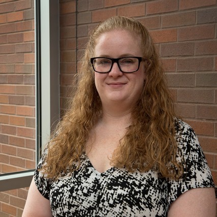 Head-and-shoulders view of woman with glasses.