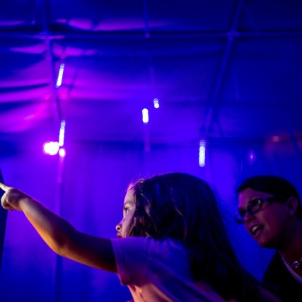 Girl and woman look at computer screen