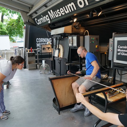 Andrea Gonzalez Esteche works with CMoG glassblowers