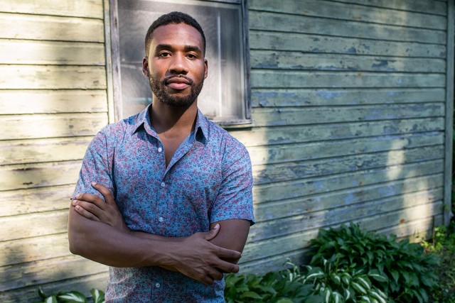 Joshua Rashaad McFadden stands outside his grandmother's house.