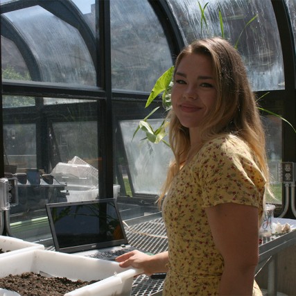 photo of Abby Rolston in the RIT greenhouse