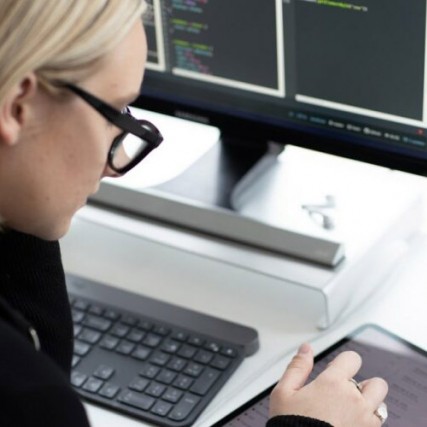 Woman looks at iPad.