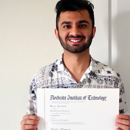 student holding a degree