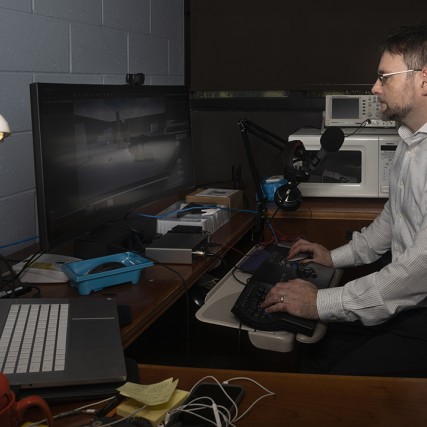 Faculty Shaun Foster works on the computer in his office.