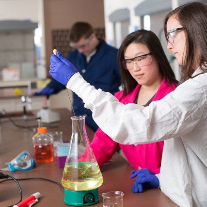biochemistry student working in lab with professor