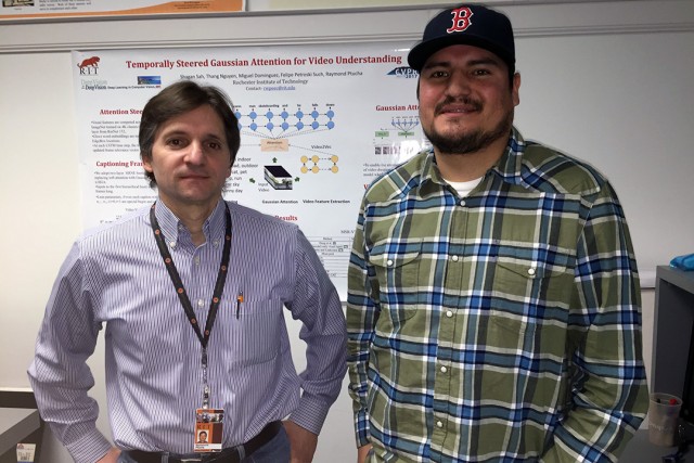 professor and student in front of poster presentation.