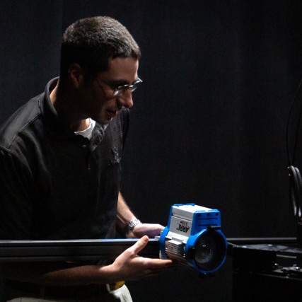 student working in digital imaging lab with camera