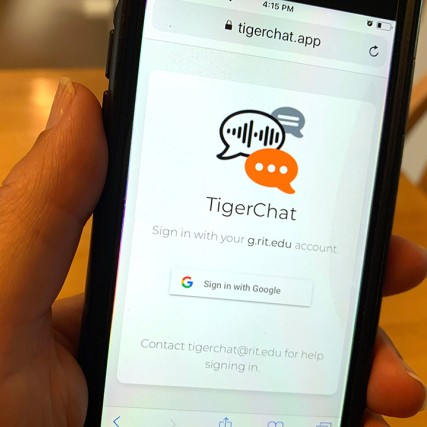 hand holding a smartphone showing the TigerChat app.
