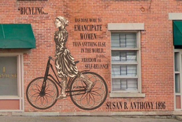 mural on a brick wall of Susan B. Anthony on a bicycle.