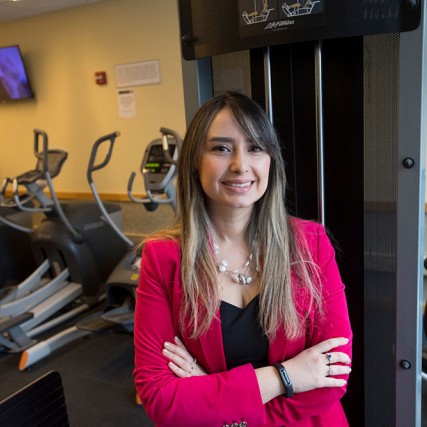 reseacher standing with gym equipment.